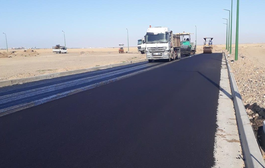 Asphalt paver laying fresh wearing course