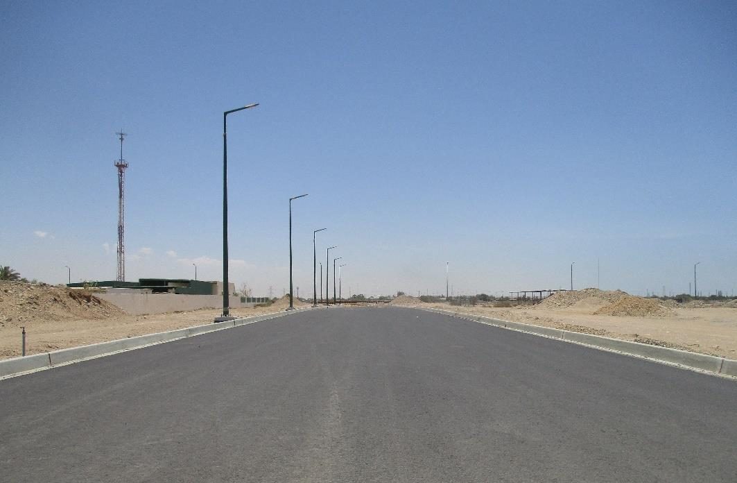 Asphalt road with street lighting installation